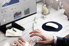 photo of a person using a computer keyboard