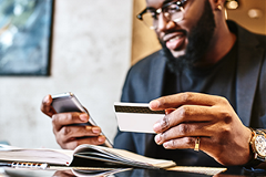 customer-experience photo of a man conducting a transaction on his smartphone