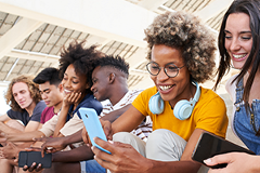 gen-z-ads photo of several Gen Z-aged people looking at their cell phones