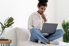photo of a young woman looking at a laptop