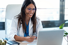 photo of a female physician looking at a computer